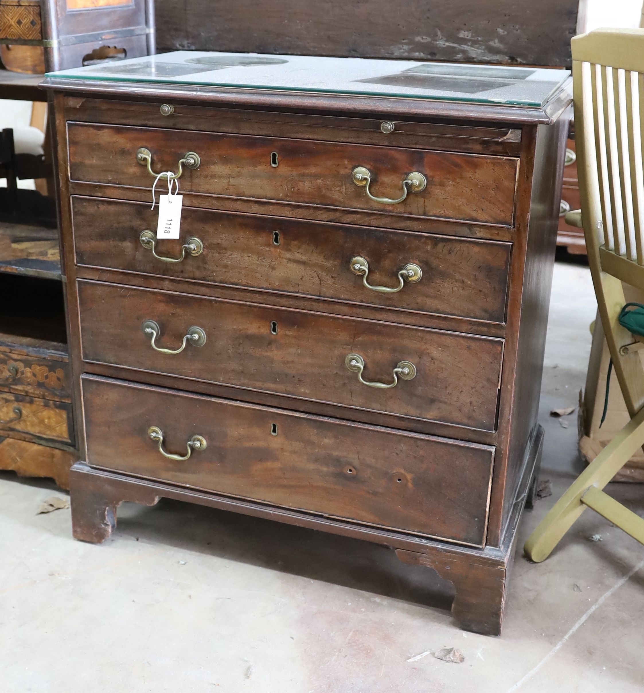 A small George III mahogany chest of three graduating long drawers and fitted slide, width 79cm, depth 47cm, height 84cm